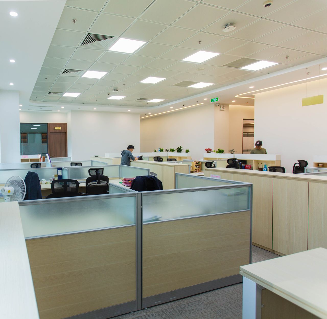 Home Spacious modern open office with workstations and natural lighting, optimal for productivity.